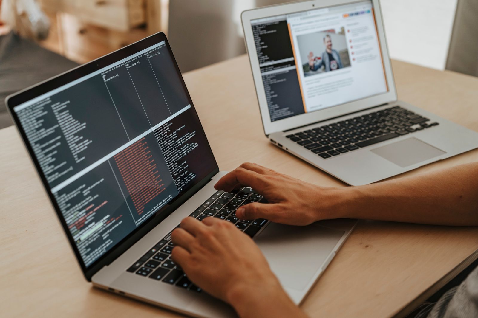 Developer working on a laptop with code on screen