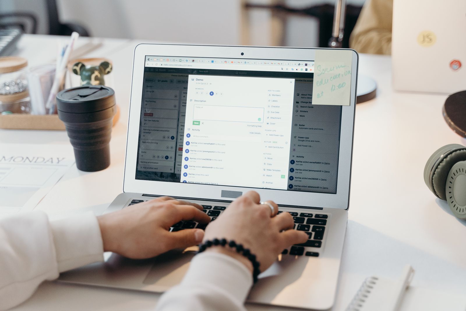 Person typing on a laptop in a bright office